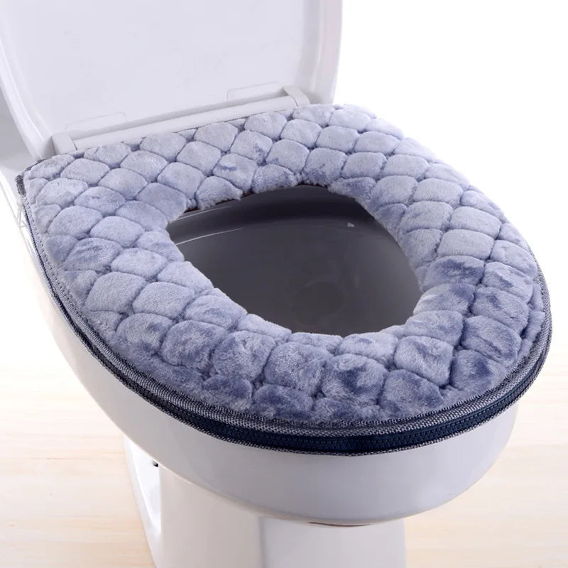 A plush, gray waterproof toilet seat cover is shown installed in a white toilet bowl.