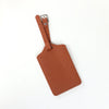 Two brown PU leather luggage tags with a leather strap and silver clasp.