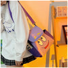 A person is holding a purple and orange Dora The Explorer cartoon flannel backpack.