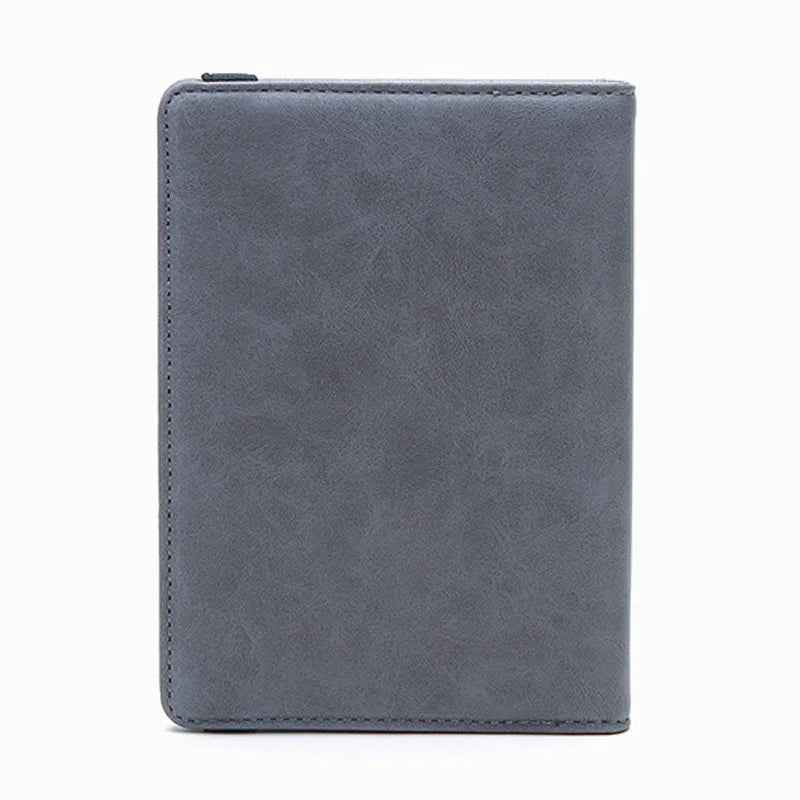 A grey unisex PU leather passport holder with a slim design.