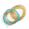 A display of colorful belly bead chains featuring turquoise blue and gold beads.