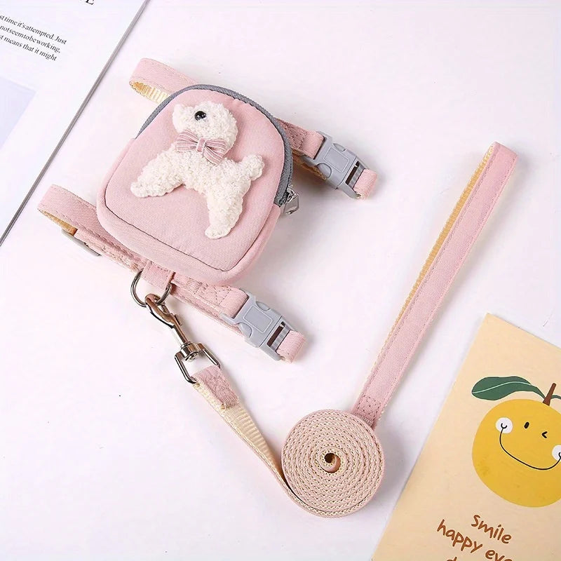 A pink adjustable dog vest with a backpack and leash featuring a white fluffy bear charm.