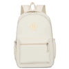 A cream-colored durable nylon commuter backpack with a flap closure and zippered pockets.