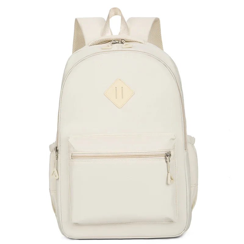 A cream-colored durable nylon commuter backpack with a flap closure and zippered pockets.