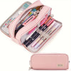 A pink multi-layer pencil case with various colored pencils and tools inside.