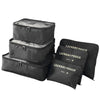 A set of black mesh packing cubes stacked and laid out for travel organization.