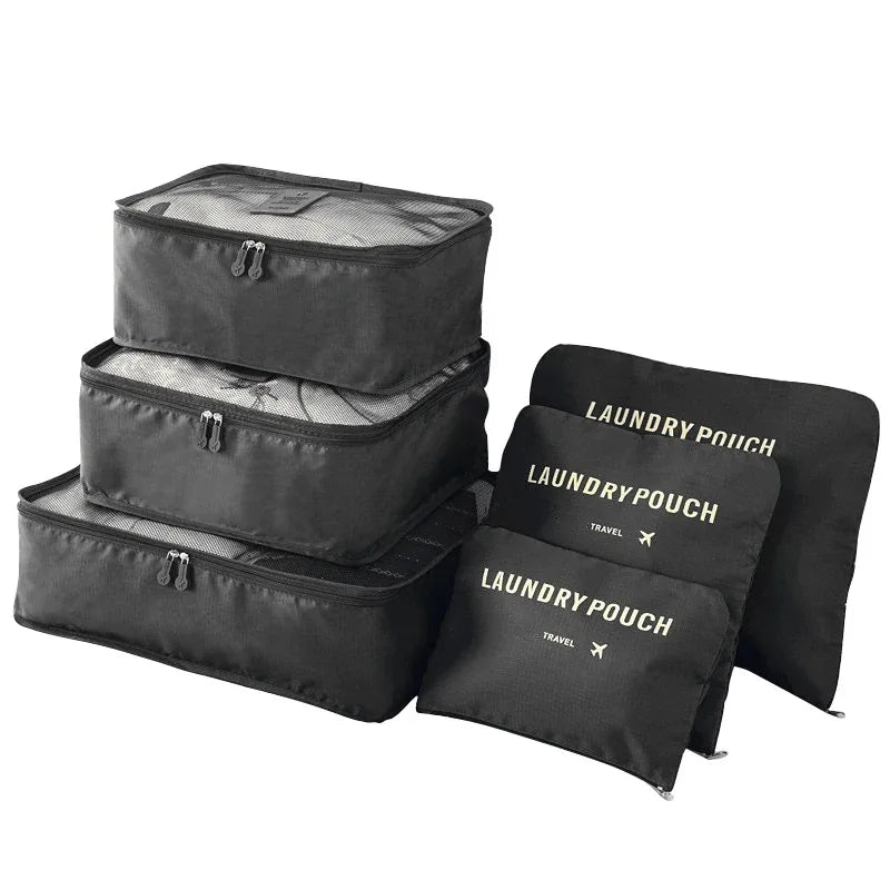 A set of black mesh packing cubes stacked and laid out for travel organization.