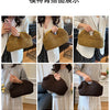 Close-up display of straw woven tote handbags in various shades of brown and dark brown.