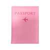 A pink leather passport holder with the word PASSPORT and a small airplane icon embossed on the cover.