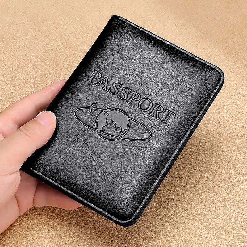 A black genuine leather passport holder with the word PASSPORT embossed and a globe design is held in a hand.
