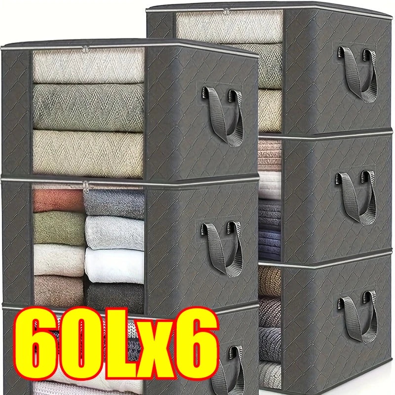 A stack of dark gray foldable storage bags filled with various textiles and clothing items.