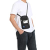 A person wearing a white t-shirt and jeans is holding an RFID-blocking travel neck wallet with an adjustable black strap.