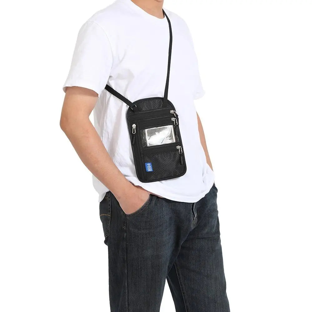 A person wearing a white t-shirt and jeans is holding an RFID-blocking travel neck wallet with an adjustable black strap.