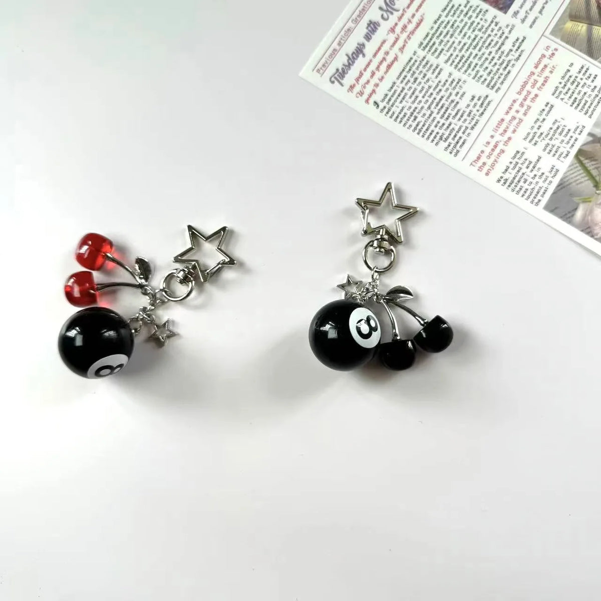 Silver Y2K 8 ball keychain charm with a star and a black marble ball.