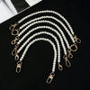Elegant pearl strap for handbags featuring multiple strands of white pearls and gold-toned clasps.