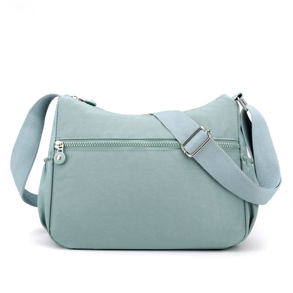 A light blue waterproof nylon crossbody shoulder bag with a zipper and strap.
