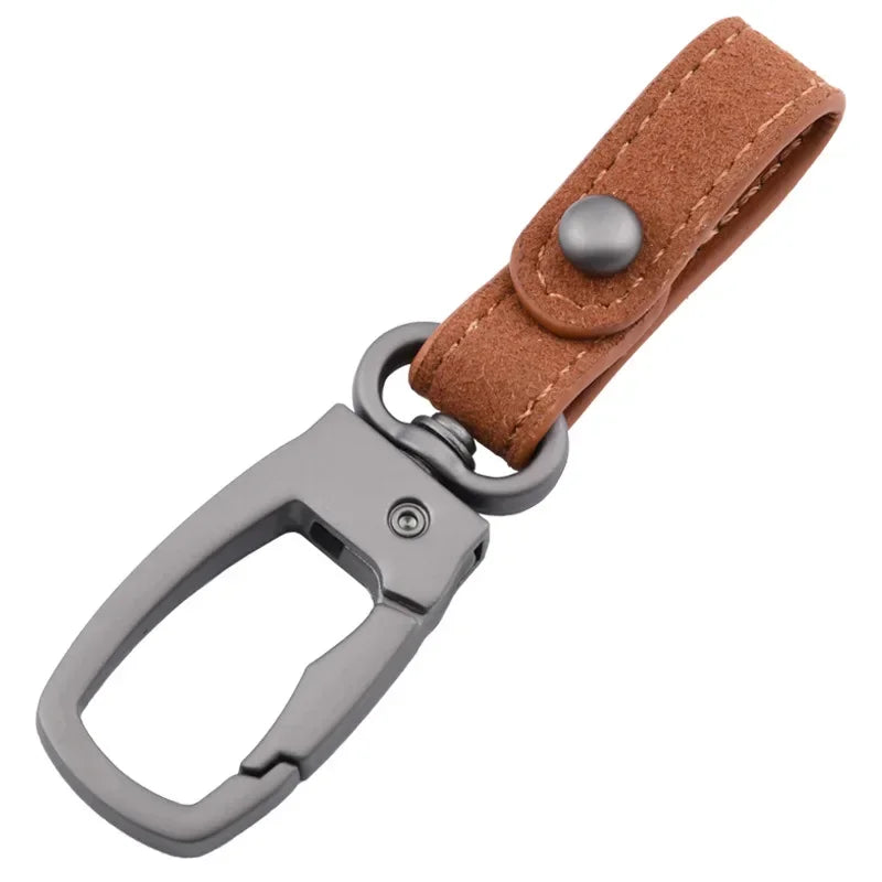 A brown leather keyring keychain with a silver clasp and a matching leather strap.