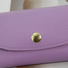 A purple PU leather hard shell sunglasses case with a gold-colored button closure.