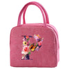 A pink insulated canvas lunch bag featuring a floral butterfly design.