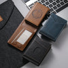 A collection of brown and blue anti-RFID blocking PU leather card holders resting on a gray surface next to a laptop.