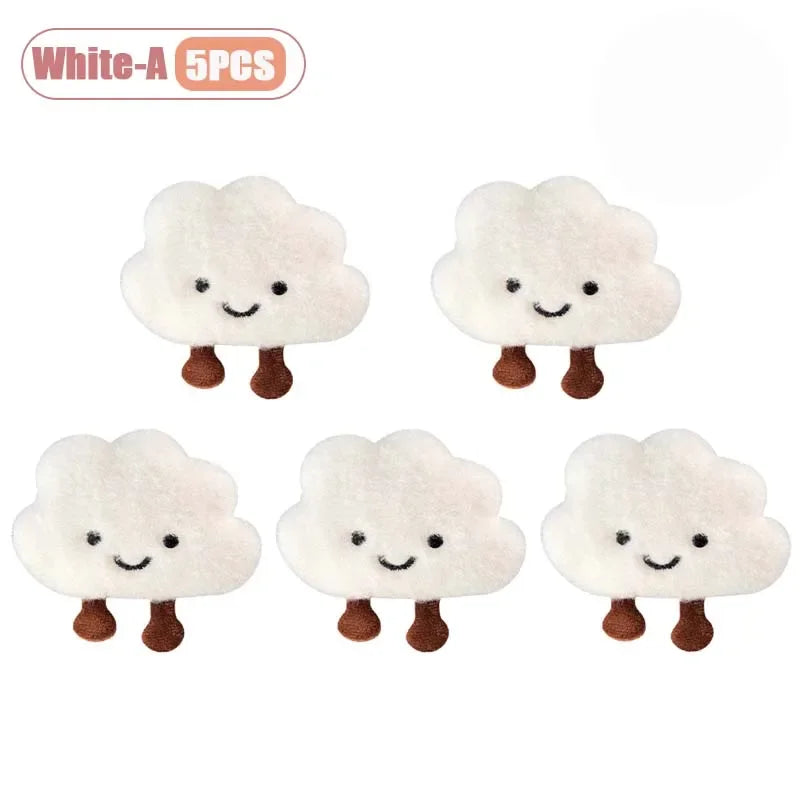 Five white cloud-shaped plush keychains and brooch pins