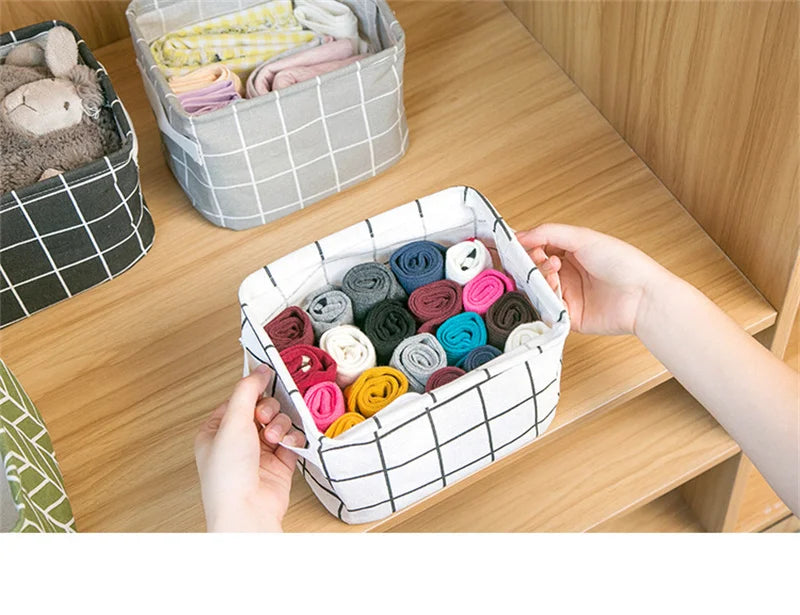 A white storage basket filled with various colored fabric scraps and yarn is shown on a wooden shelf.