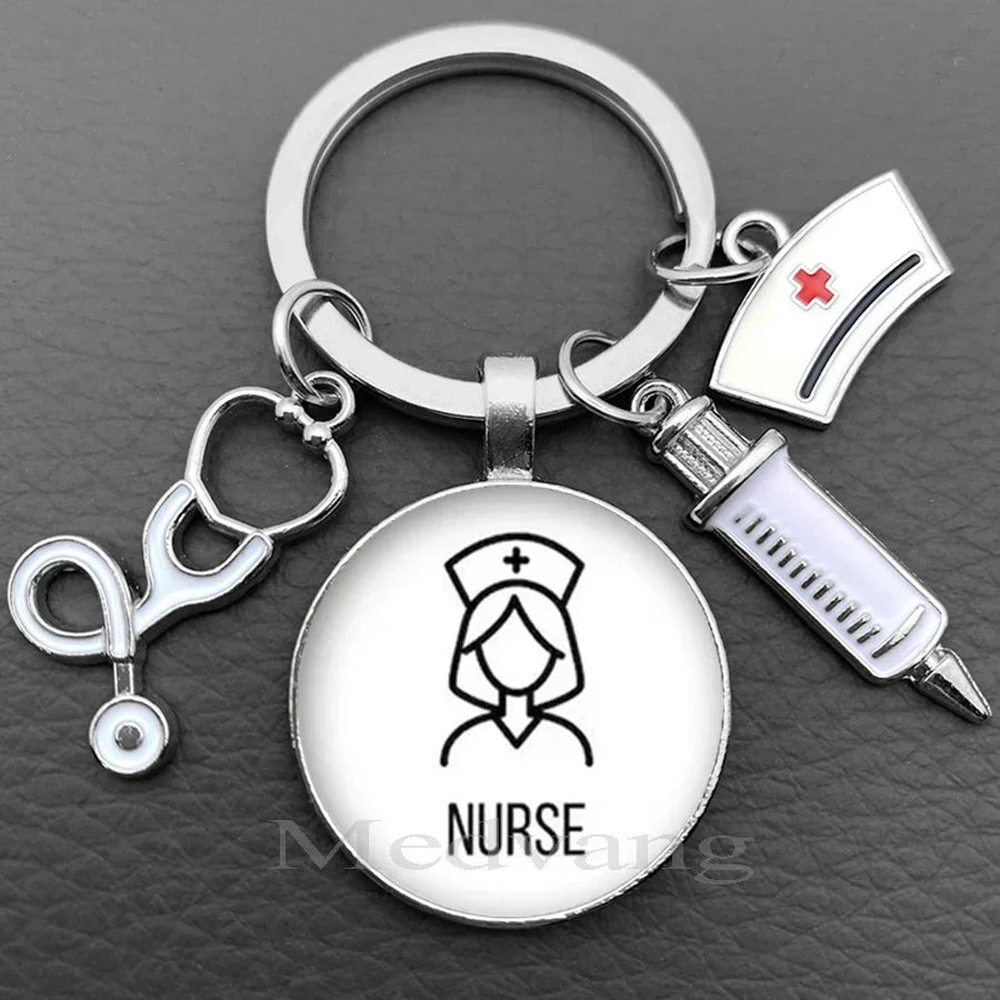 Silver keychain featuring a nurse symbol, a medical cross, and a stethoscope charm.