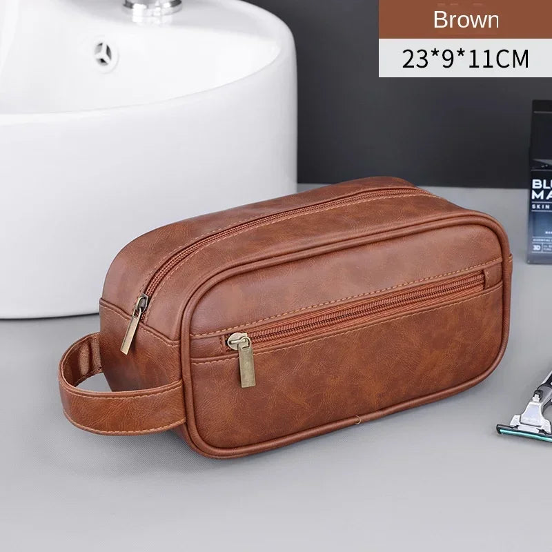 A brown leather travel cosmetic bag is shown next to a white sink, with dimensions 23x9x11cm.