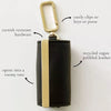 A black pebbled leather storage pouch with a gold-toned clip and hardware.