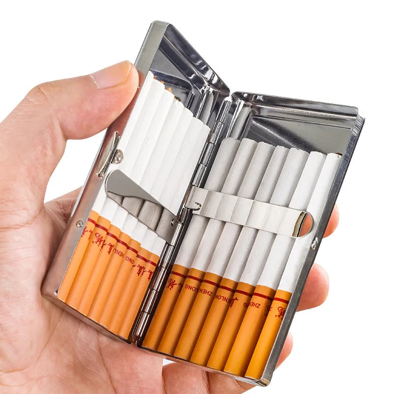 A hand holds an open premium metal cigarette holder displaying several white and orange-tipped cigarettes.