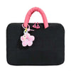 Black quilted laptop sleeve with a pink fabric handle and decorative flower charm