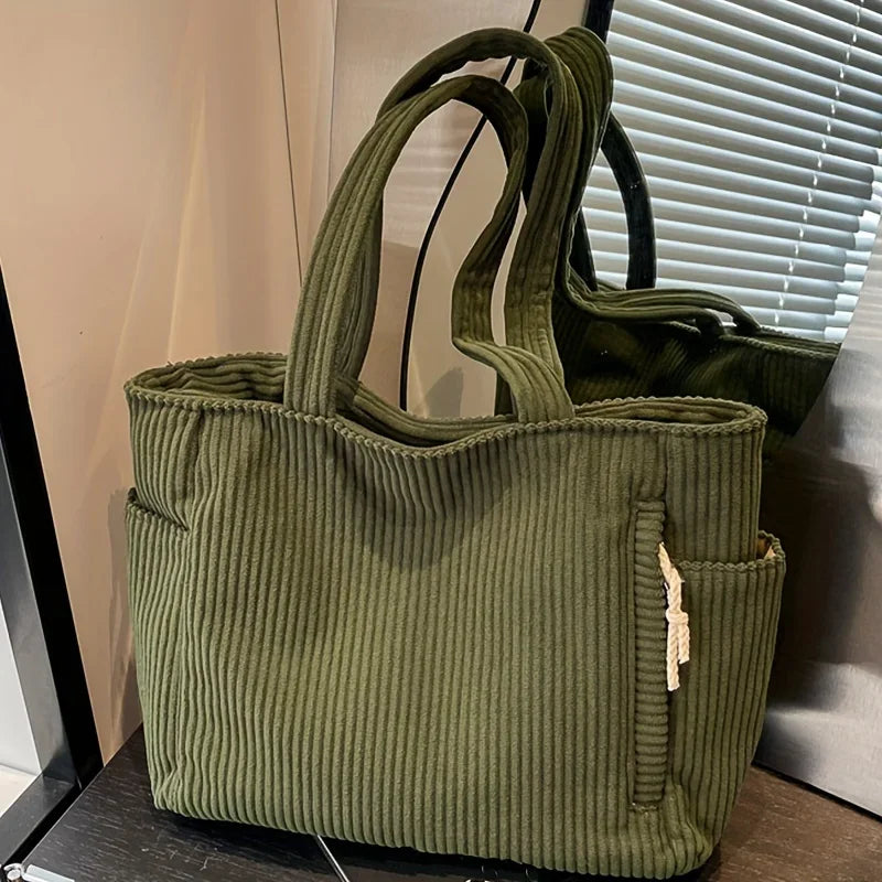 A olive green corduroy casual handbag with vertical ribbing shown against a light background.