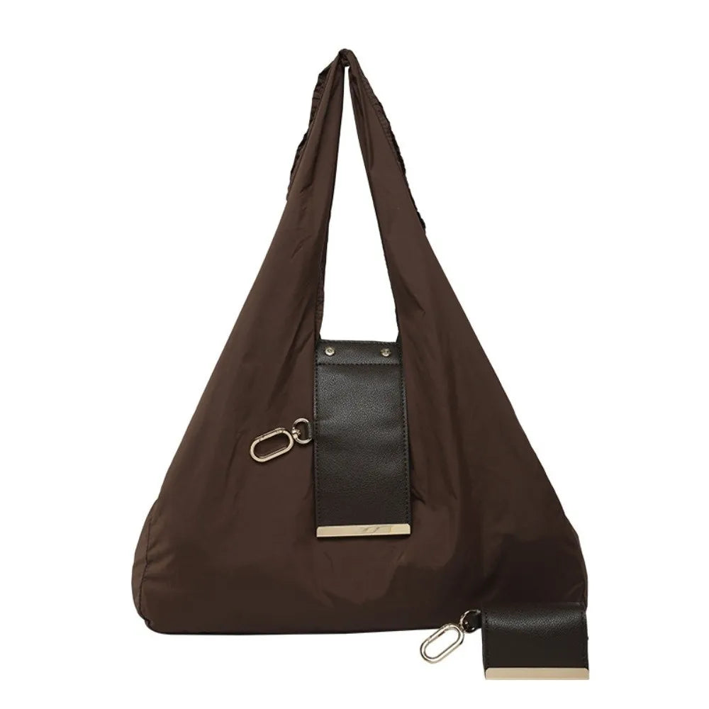 A dark brown reusable nylon mini keychain tote bag with a leather accent and gold hardware.