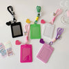 A collection of pink, green, and purple PU credit card and ID holders attached to keychains.