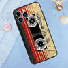 A phone case featuring a vintage cassette tape design with red stripes and black discs on a gold background.