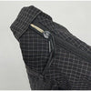 Close-up of a black plaid nylon drawstring tote bag featuring a zipper detail.