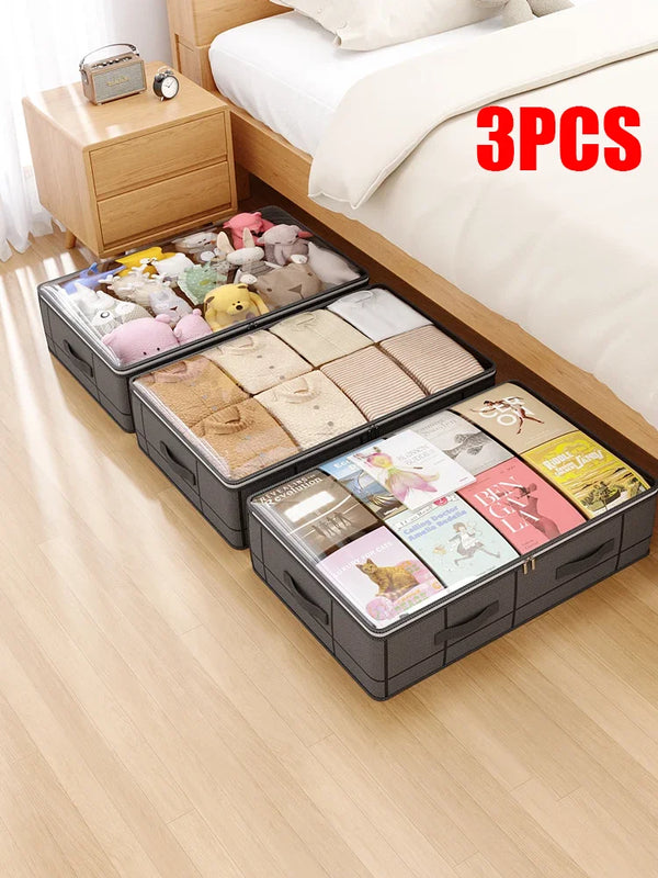 Three foldable under-bed storage boxes filled with soft toys and fabric items placed on a wooden floor.