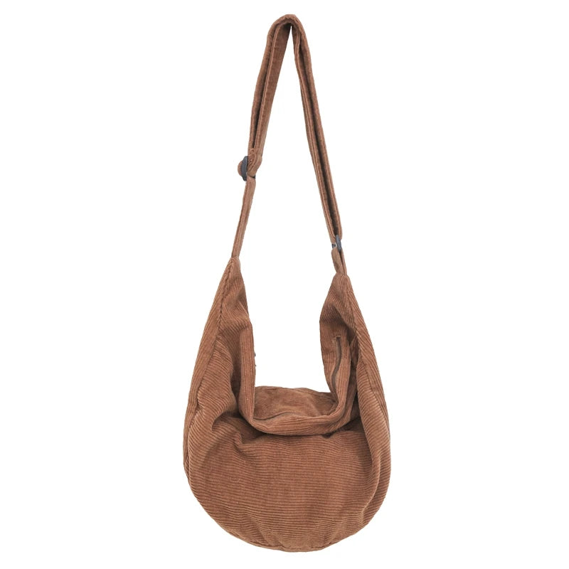 A brown corduroy casual crossbody shoulder bag hanging by its strap.