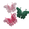 Three decorative butterfly appliqués or stickers in pink and green glitter.