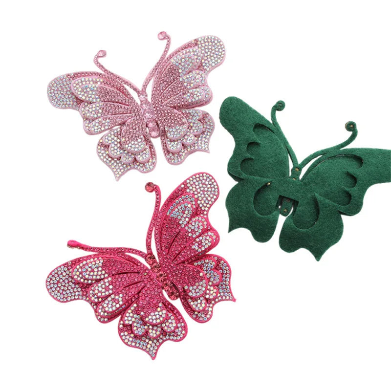 Three decorative butterfly appliqués or stickers in pink and green glitter.