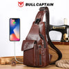 A brown genuine leather sling backpack is shown next to a hair styling tool and a smartphone.