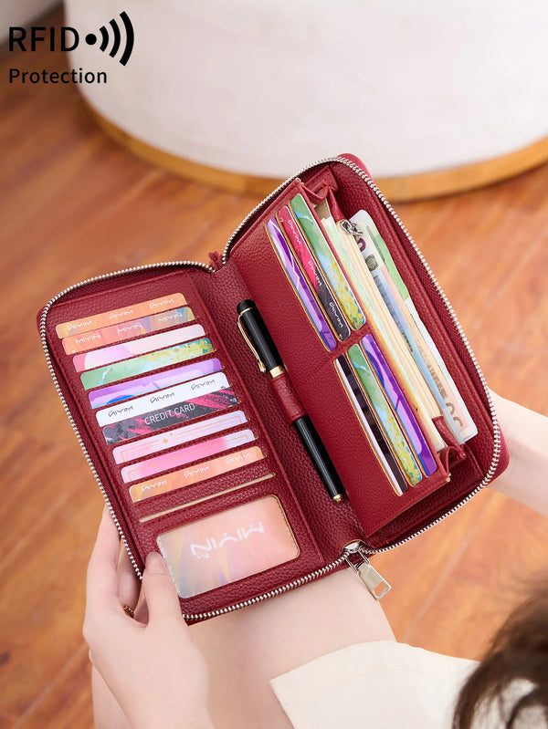 A close-up of a maroon PU leather zipper wallet with multiple card slots and a pen inside.