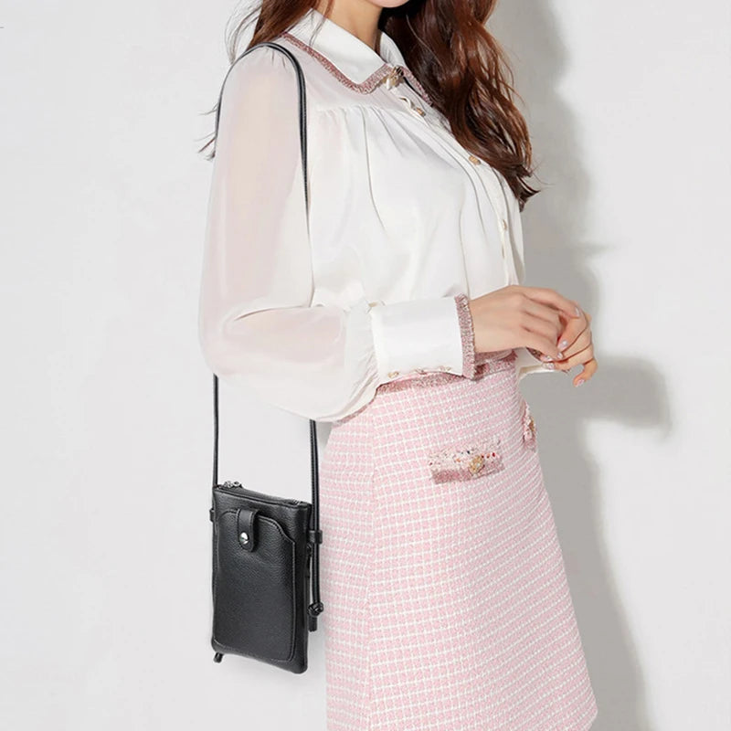 A woman wearing a white blouse and pink checkered skirt, carrying a black PU leather crossbody bag.