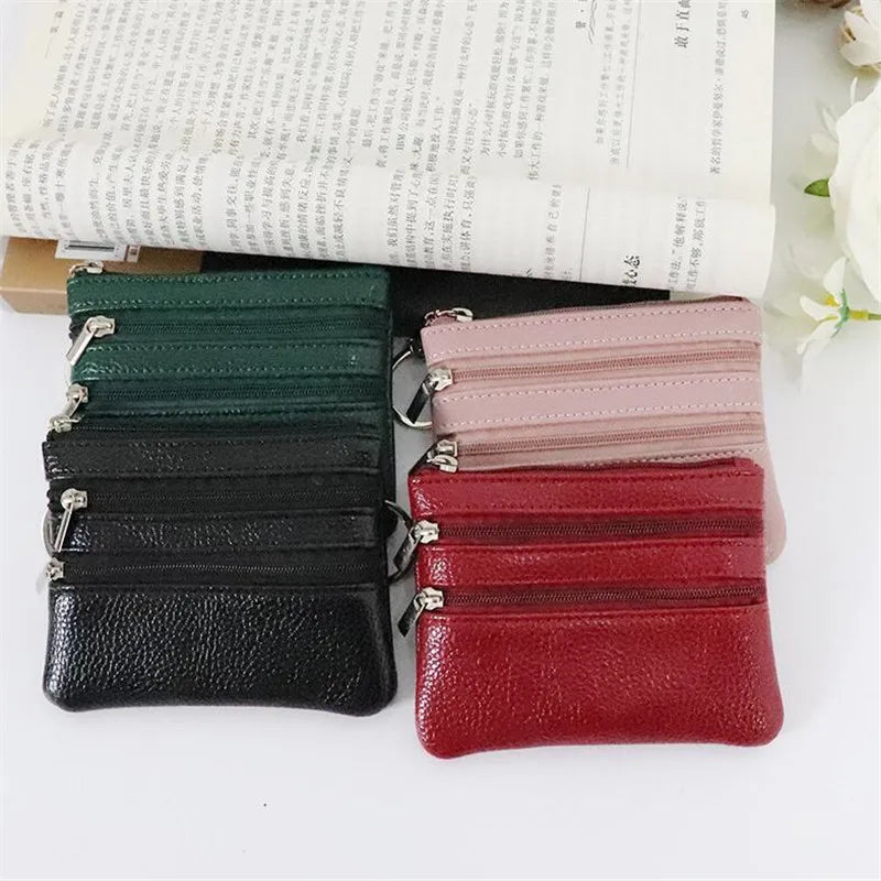A set of five foldable PU leather clutch wallets in various shades of green, black, pink, and red stacked on a light backgrou
