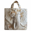 Bolso tote acolchado vintage con diseño detallado de elefante en tonos blanco hueso y dorado.