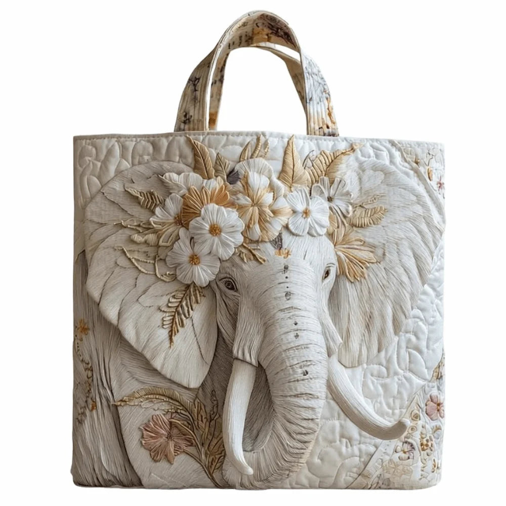 Bolso tote acolchado vintage con diseño detallado de elefante en tonos blanco hueso y dorado.