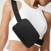A white ribbed crop top worn by a woman, featuring a black waist bag attached to the garment.