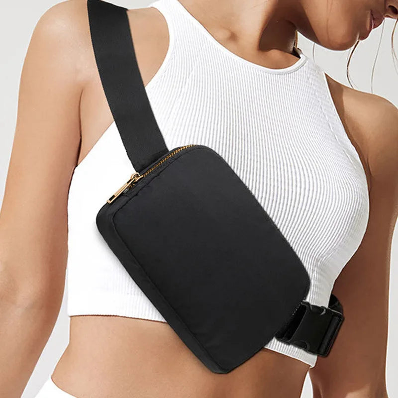 A white ribbed crop top worn by a woman, featuring a black waist bag attached to the garment.