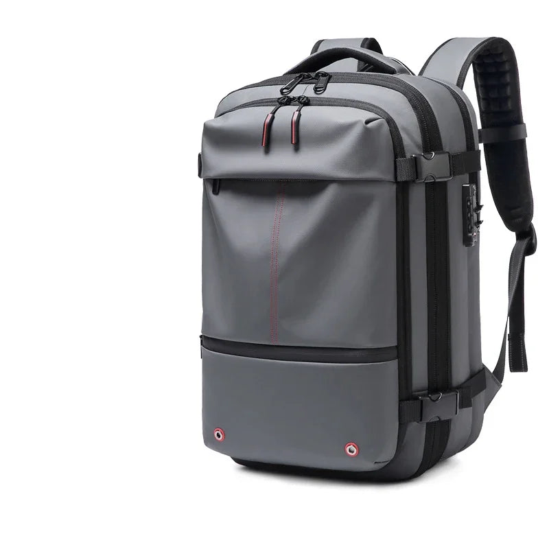 A gray heavy duty laptop backpack featuring vacuum compression features and black straps.