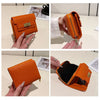 Orange leather card holder shown in multiple angles with a zipper detail and gold hardware.